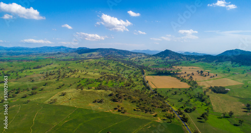 Aerial panoramic landscape of Australian countryside - green fields and hills