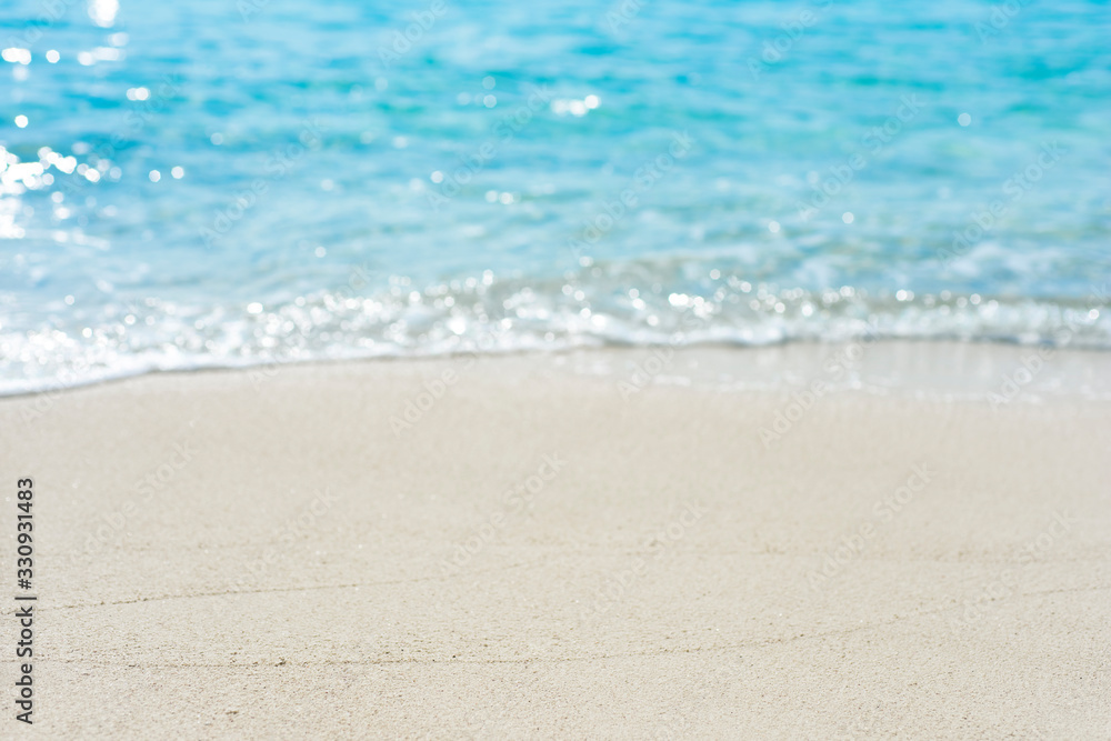 Summer vacation concept with sand and blurred tropical beach background Summer vacation concept with sand and blurred tropical beach background