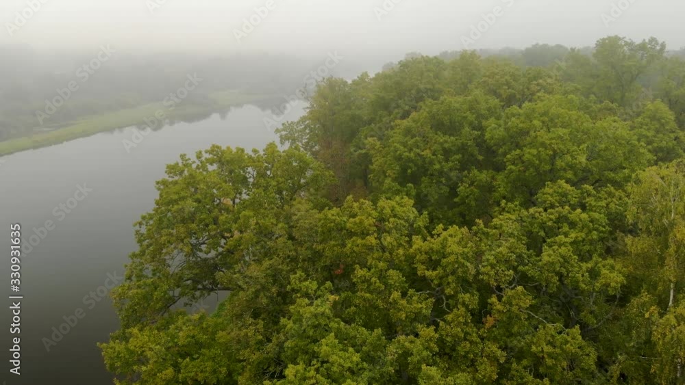 Fantastic misty river with fresh green trees reflecting in the water. Dramatic colorful landscapes. The world of beauty , the view from the top Fantastic misty river with fresh green trees reflecting in the water. Dramatic colorful landscapes. The world of beauty , the view from the top