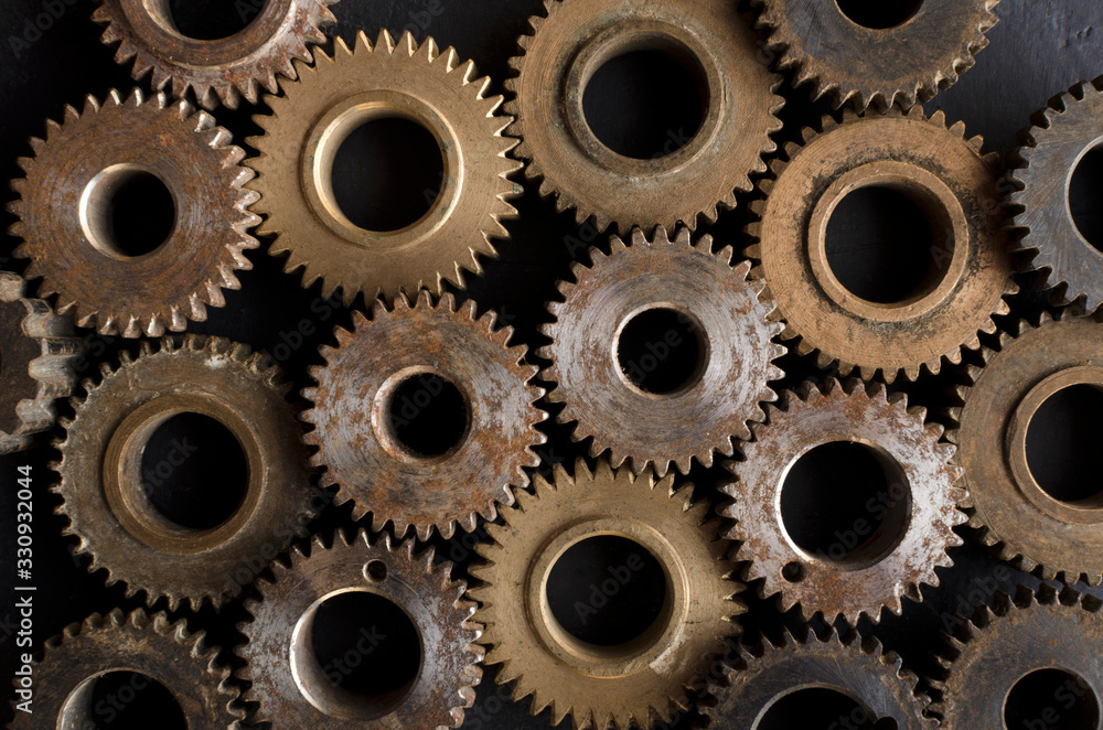 Closeup of lot of gears as a background.Broze and silver color gears Closeup of lot of gears as a background.Broze and silver color gears