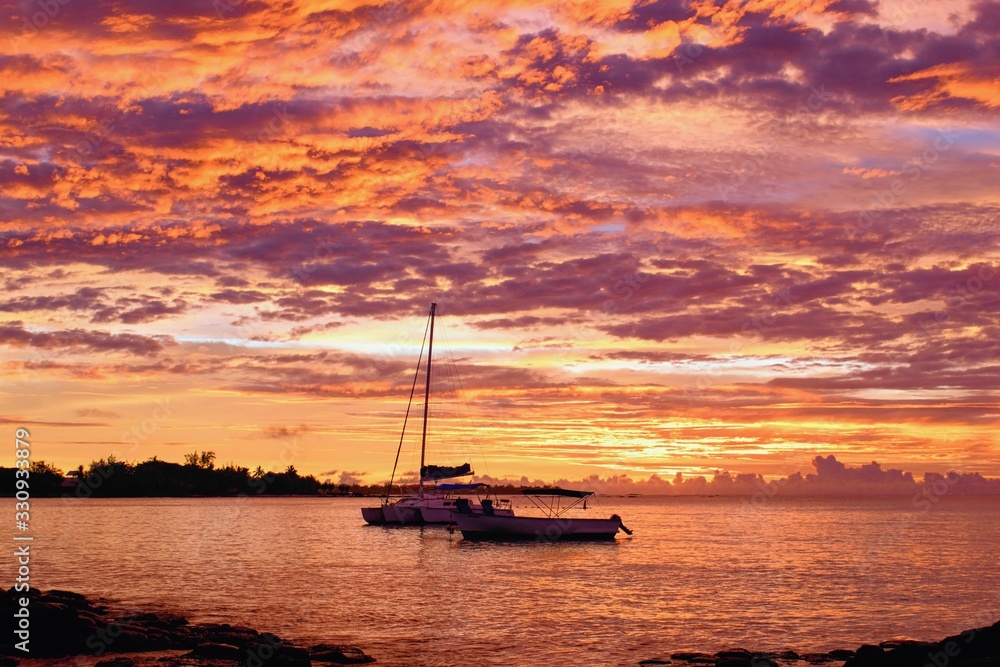 Yacht on the sea within a beautiful colorful sunset, Grand Baie, Mauritius Yacht on the sea within a beautiful colorful sunset, Grand Baie, Mauritius