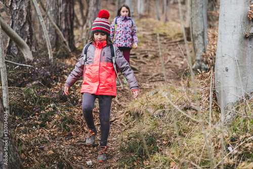 Children hiking in the mountains or woods on family trip.