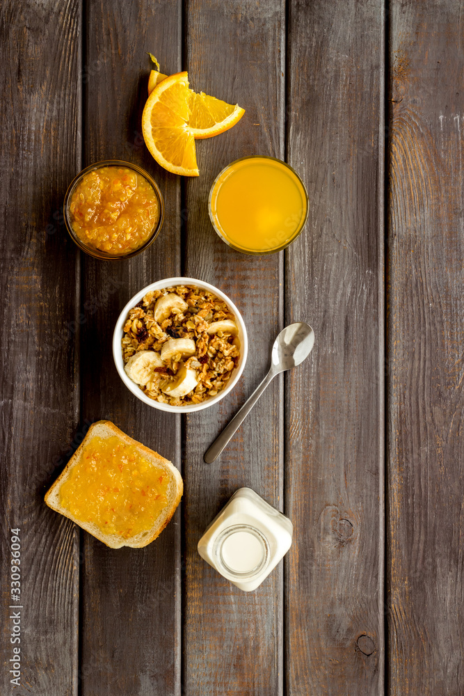 Granola for healthy breakfast. Still life composition with fruits and toast on wooden background top-down Granola for healthy breakfast. Still life composition with fruits and toast on wooden background top-down