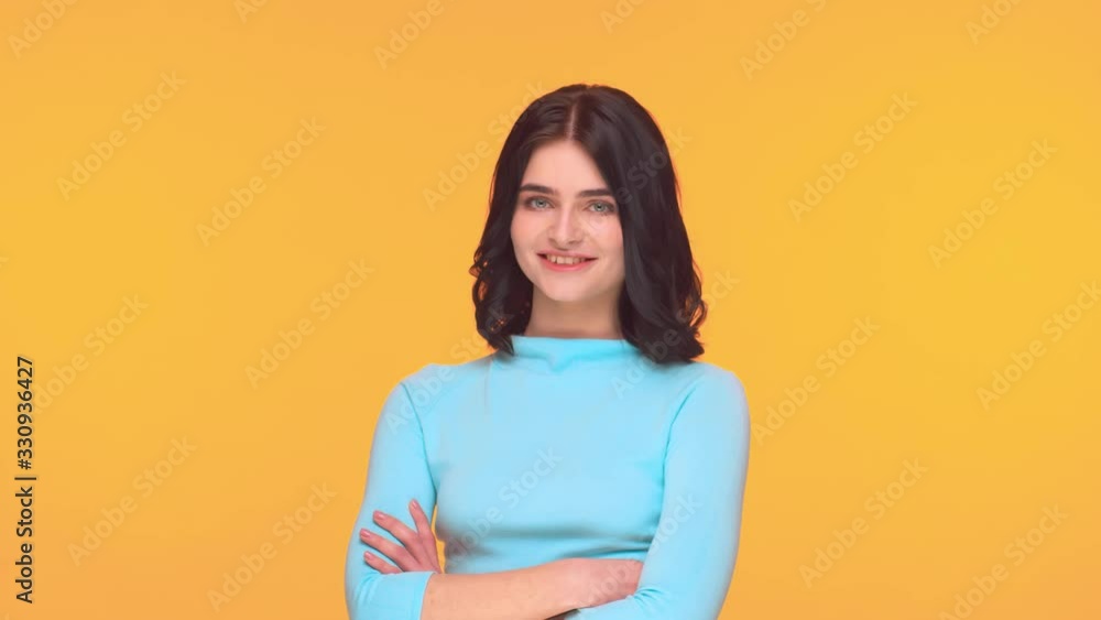 Studio portrait of young and expressive teenage girl over yellow background. Studio portrait of young and expressive teenage girl over yellow background.