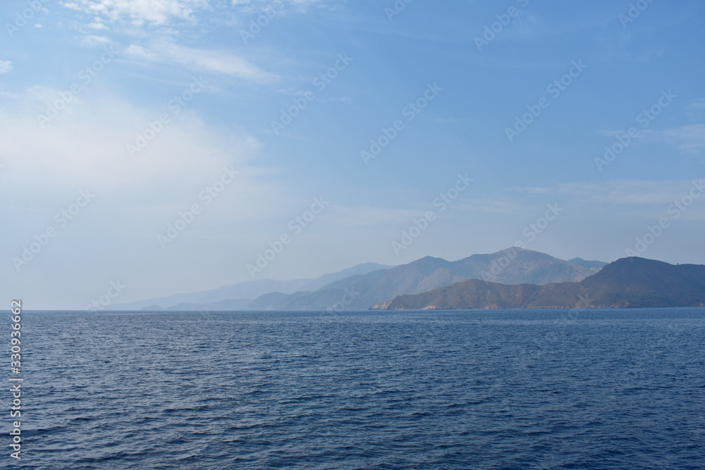 silhouettes of mountains on the Aegean sea.