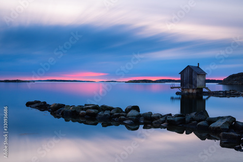 Waterfront house at the sea during sunset, Sweden.
