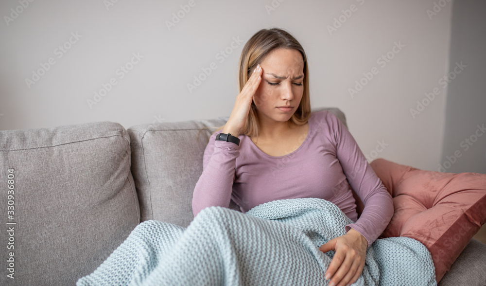 Portrait of tired young woman suffering from headache Portrait of tired young woman suffering from headache