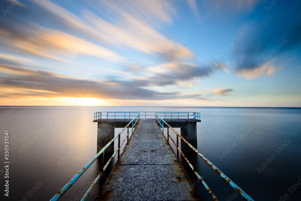 Fototapeta premium Jetty with railings leading into the sea, Madeira.