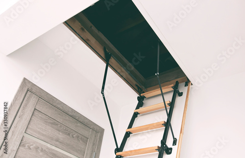 Wooden staircase to the attic in the house