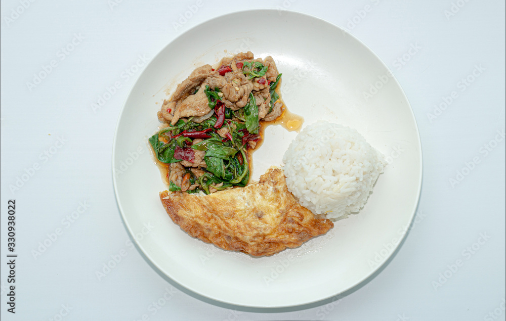 Thai food menu with spicy basil fried with pork and serve with omlet egg