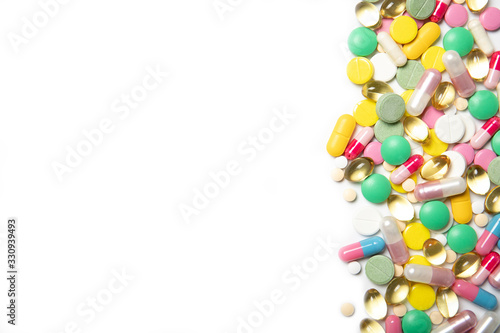 A lot of multi-colored pills on a white background. Dietary supplements. Place for text. Coronavirus