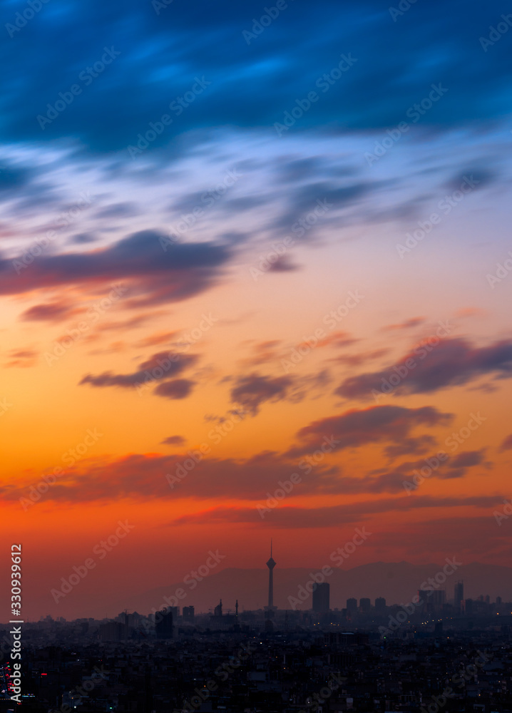 Beautiful sunset over Tehran skyline with Milad tower in the Frame and amazing colorful sky. Beautiful sunset over Tehran skyline with Milad tower in the Frame and amazing colorful sky.