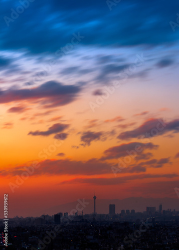 Beautiful sunset over Tehran skyline with Milad tower in the Frame and amazing colorful sky.