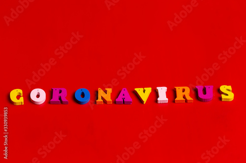 Pandemic and virus concept - Coronavirus word made of colourful blocks. Coronavirus text on red background. Coronavirus concept top view.