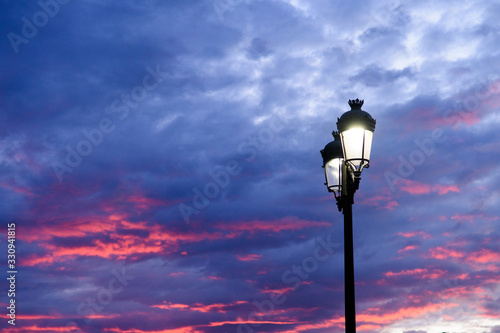 isolated streetlight with clouds at background photo