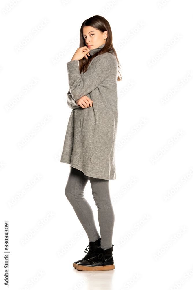 Side view of young beautiful woman in gray tunic Side view of young beautiful woman in gray tunic