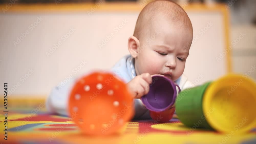 little toddler plays with toys lying on the floor in the house little toddler plays with toys lying on the floor in the house