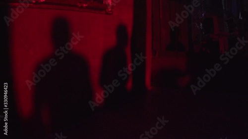 silhouette people are dancing on the wall