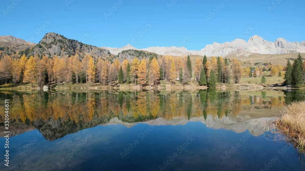 Autumn alpine mountain lake near San Pellegrino Pass, Trentino, Dolomites Alps, Italy. Picturesque traveling, seasonal and nature beauty concept scene. Autumn alpine mountain lake near San Pellegrino Pass, Trentino, Dolomites Alps, Italy. Picturesque traveling, seasonal and nature beauty concept scene.