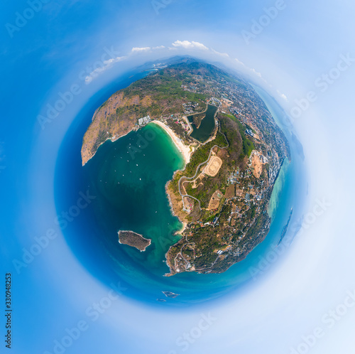 Aerial view of the coastline of Phuket island in the form of a little planet. Thailand