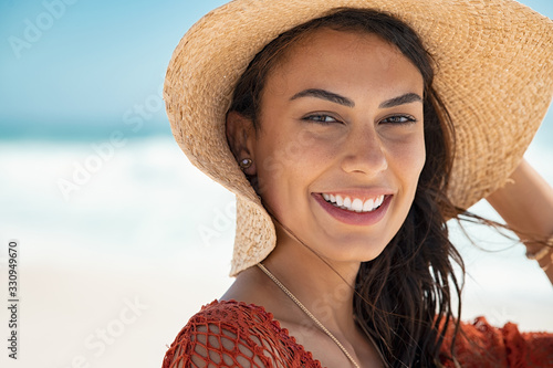 Sticker Beautiful girl with straw hat at beach