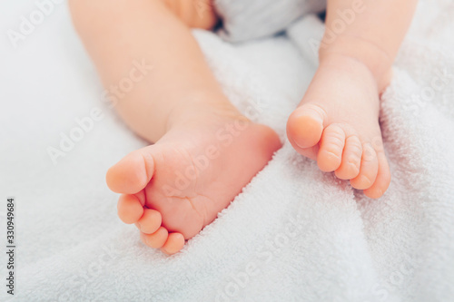 Newborn baby on a white blanket