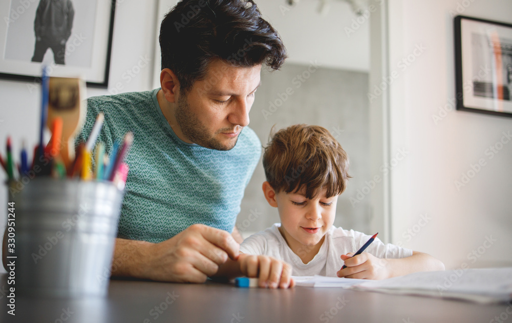 Father and Son doing homework Together - obrazy, fototapety, plakaty 