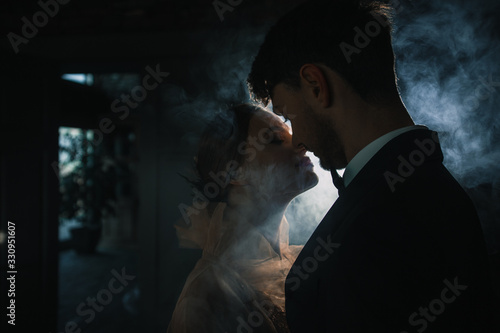 wedding couple kisses in the smoke