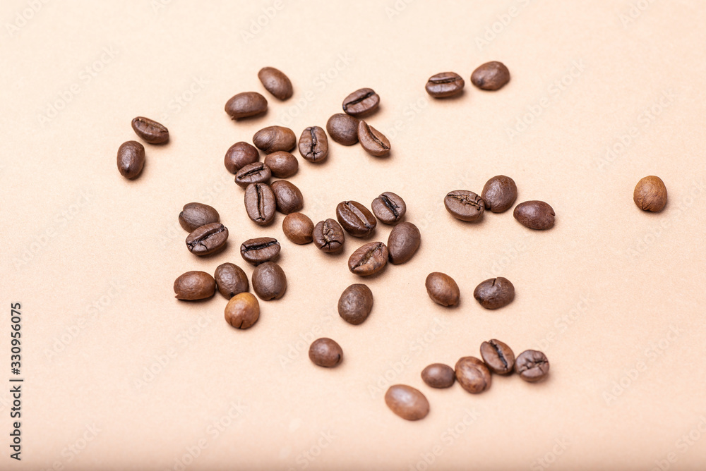 group of coffee beans on a brown background group of coffee beans on a brown background