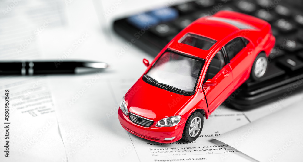 red car, calculator closeup on the paper form red car, calculator closeup on the paper form