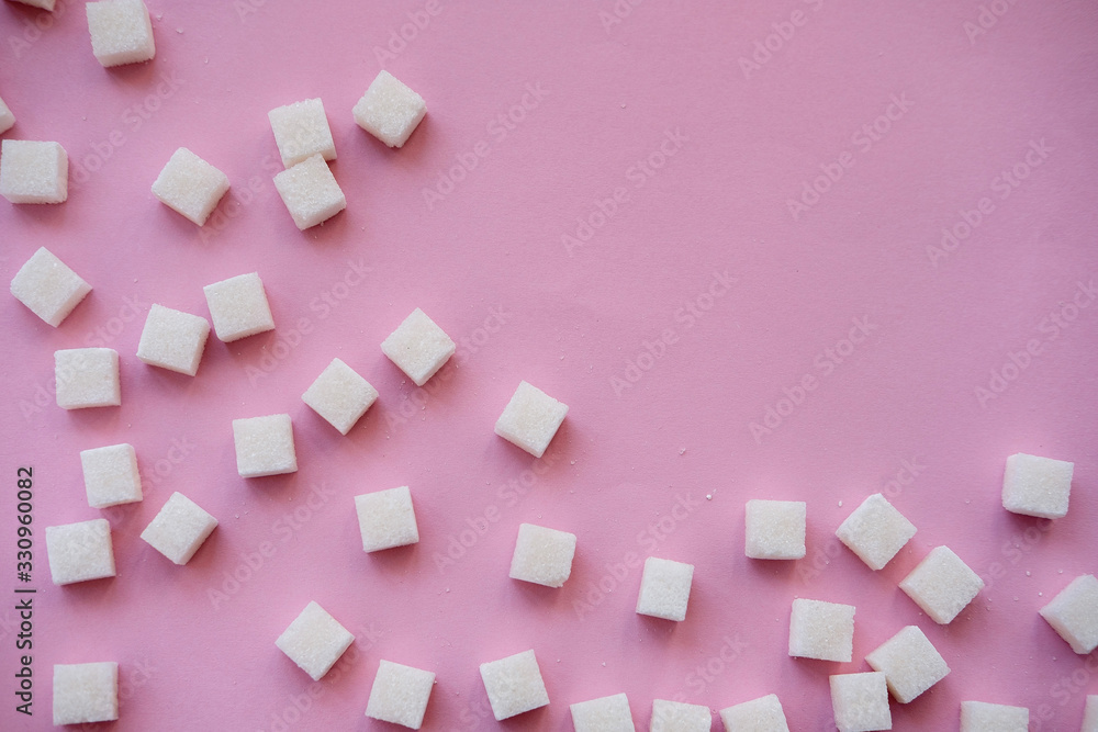 Sugar cubes and sweetener on pink background. Diabetes, sugar disease, unhealthy food, diet concept. Copy space Sugar cubes and sweetener on pink background. Diabetes, sugar disease, unhealthy food, diet concept. Copy space