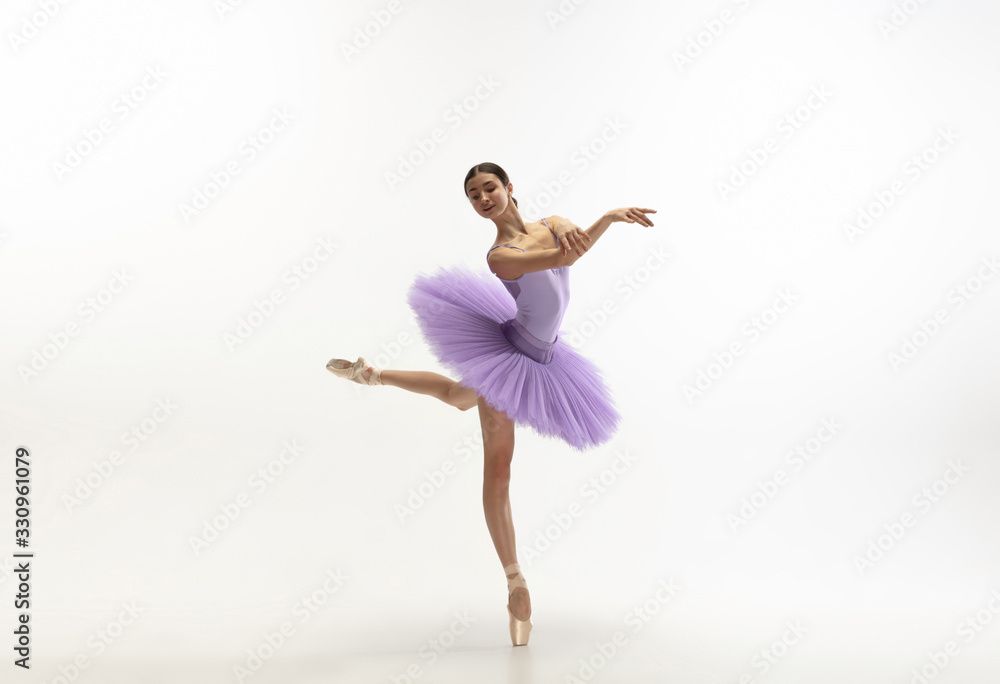 Graceful classic ballerina dancing, posing isolated on white studio background. Bright purple tutu. The grace, artist, movement, action and motion concept. Looks weightless, flexible. Fashion, style. Graceful classic ballerina dancing, posing isolated on white studio background. Bright purple tutu. The grace, artist, movement, action and motion concept. Looks weightless, flexible. Fashion, style.