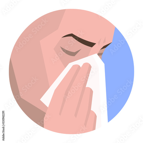 Sick person sneezing into a tissue