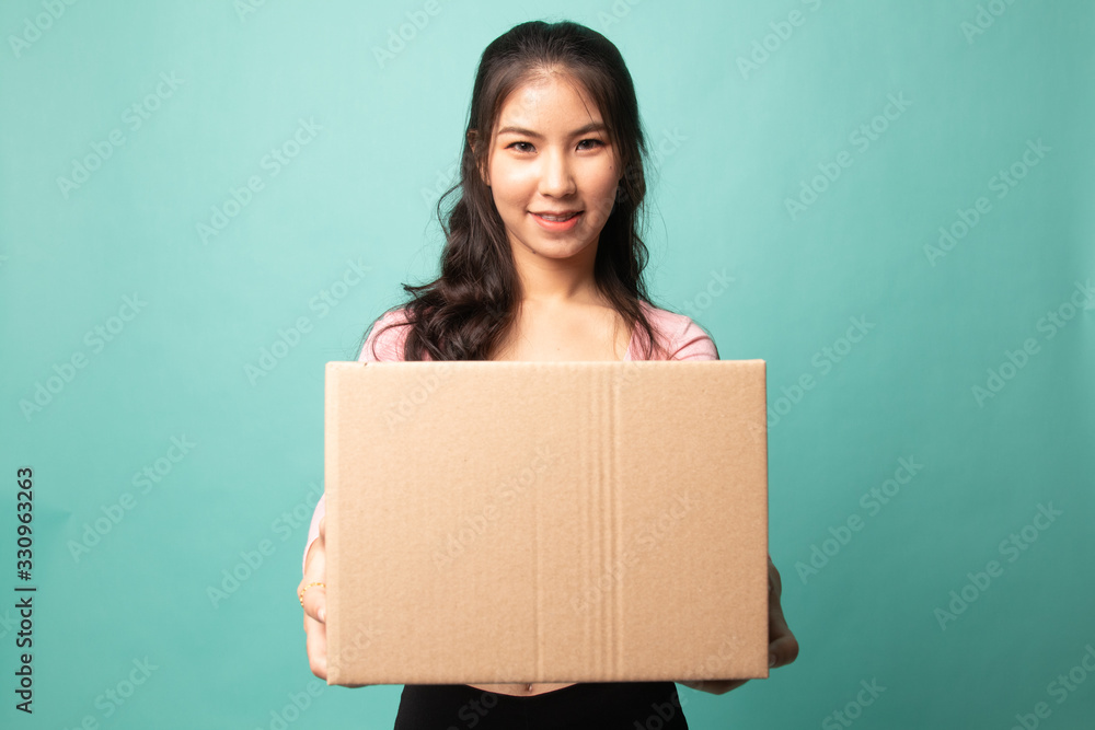 Delivery, relocation and unpacking. young asian woman holding cardboard box. Delivery, relocation and unpacking. young asian woman holding cardboard box.