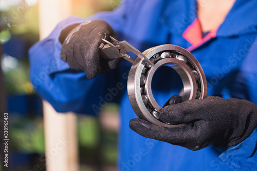 the abstract image of the technician maturing the ball bearing in the industrial factory. the concept of clean energy, futuristic, industrial4.0 and internet of things.