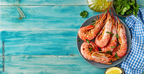Top view of argentinian red prawns on aqua menthe background photo