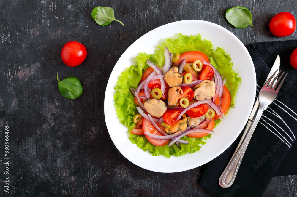 Salad of marinated mussels, fresh tomatoes, red onions, olives in a bowl on a black background Salad of marinated mussels, fresh tomatoes, red onions, olives in a bowl on a black background