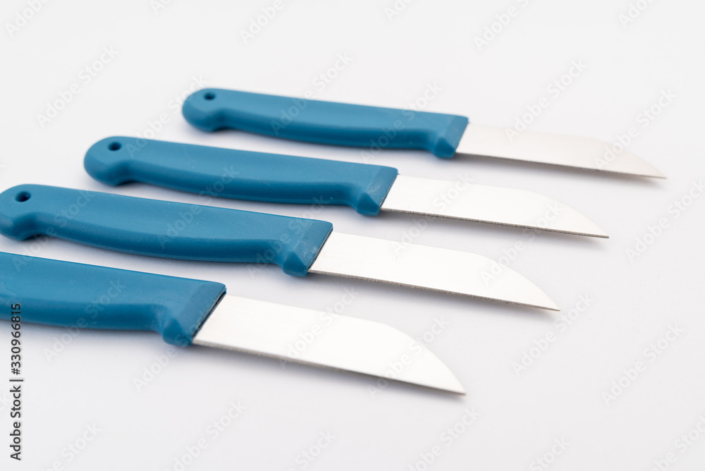 Obraz premium four sharp knives with blue plastic handle on white background