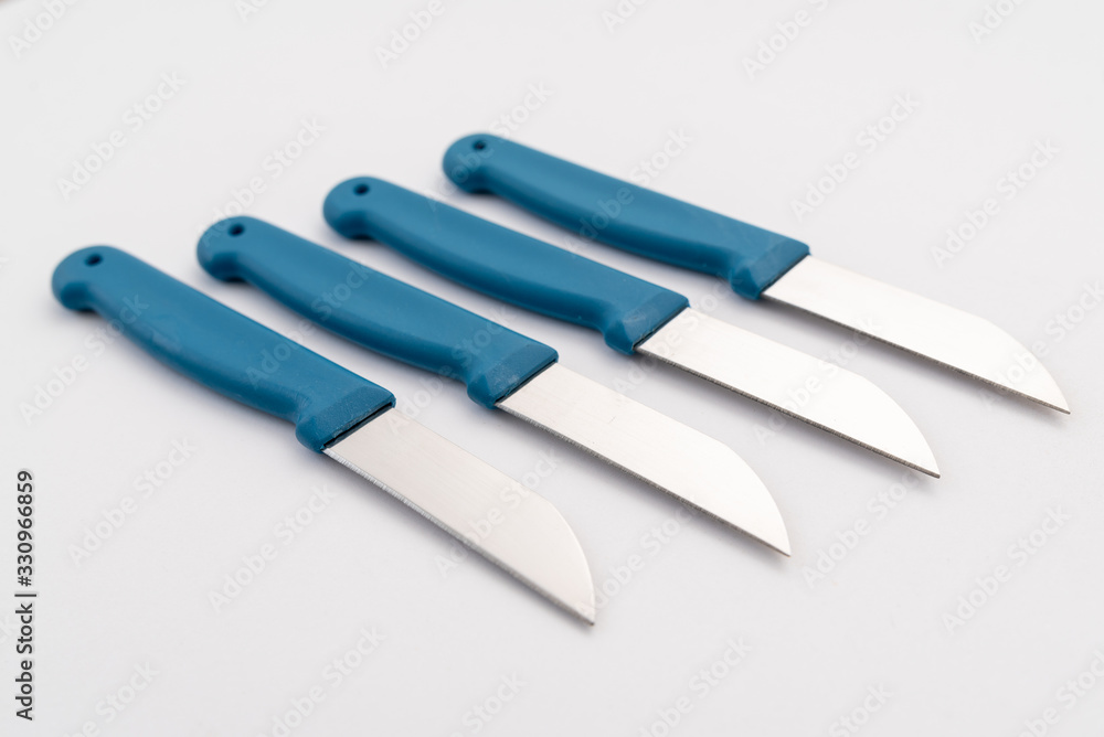 four sharp knives with blue plastic handle on white background four sharp knives with blue plastic handle on white background