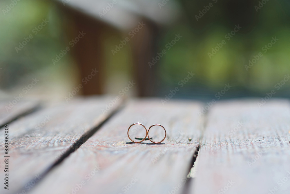 wedding rings on wooden table wedding rings on wooden table
