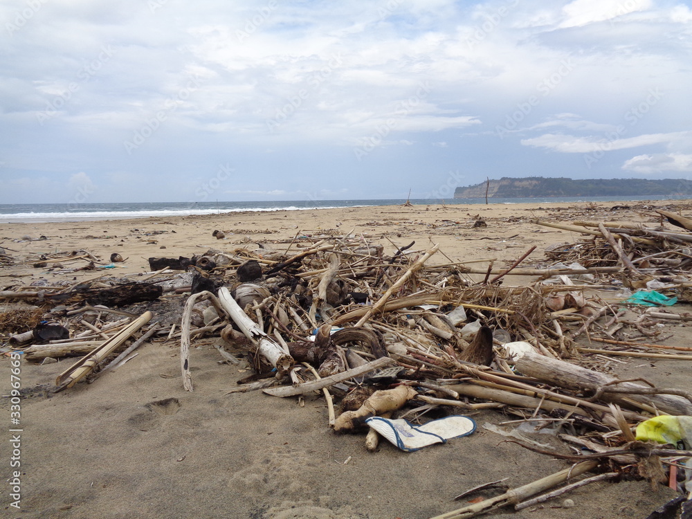 Rubbish in the beach make looks dirty and messy. the pollution because many plastic, wood and others waste.