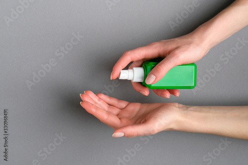 Woman applying antibacterial sanitizer spay for hand. Coronavirus Disease (Covid-19) prevention and health protection during flu virus outbreak concept.