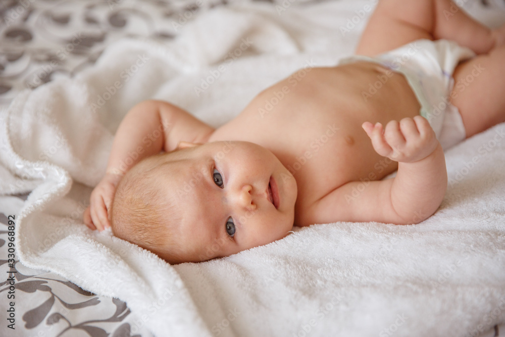newborn baby sleeping in bed. a newborn baby is lying on the bed at home newborn baby sleeping in bed. a newborn baby is lying on the bed at home