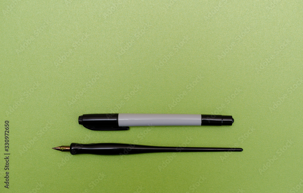 Calligraphy pen and marker on blank green textured paper Calligraphy pen and marker on blank green textured paper