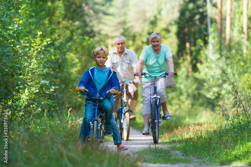 active senior couple with kids riding bikes in nature © nadezhda1906