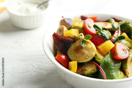 Vászonkép Delicious salad with roasted Brussels sprouts on white wooden table, closeup