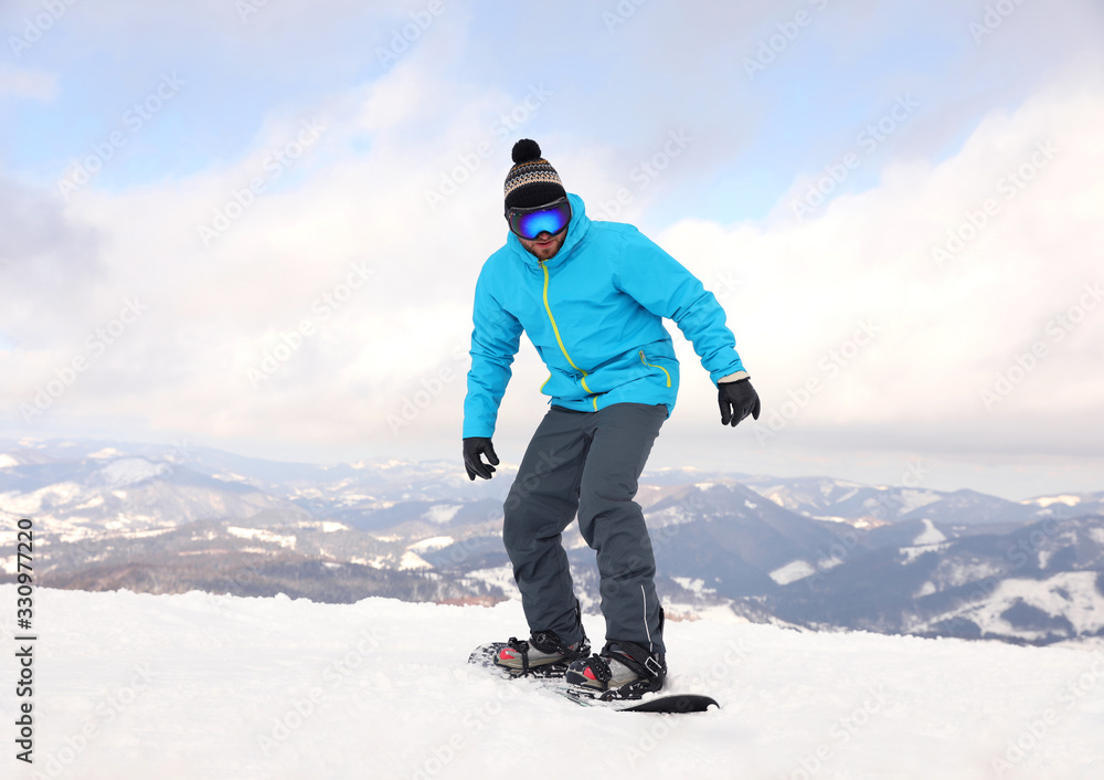 Male snowboarder on snowy hill. Winter vacation Male snowboarder on snowy hill. Winter vacation