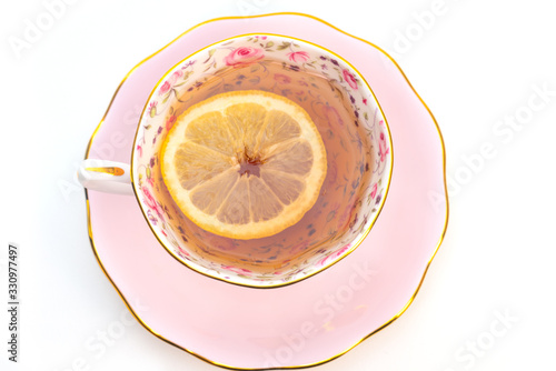 Black tea with lemon in ornamental porcelain cup