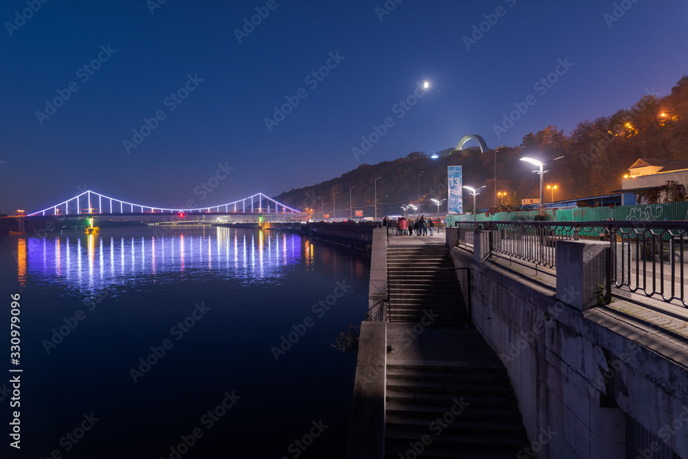 Scenic view over Pedestrian bridge over the Dnipro river in Kiev at night