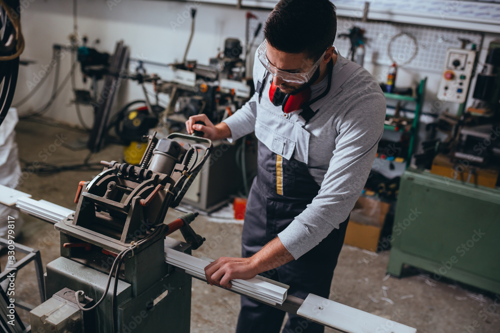 Aluminium and PVC industry worker making PVC or aluminium frames for windows and doors Aluminium and PVC industry worker making PVC or aluminium frames for windows and doors